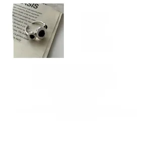 Detail of S925 sterling silver ring with three black oval agate stones and adjustable band