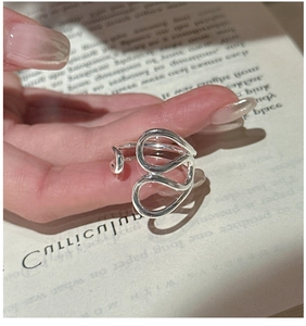 Close-up of S925 sterling silver multi-layered wrap ring with irregular curved design