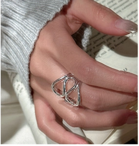 Close-up of minimalist S925 sterling silver multi-layer fluid ring on finger