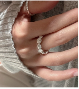 Close-up of S925 sterling silver matte rose flower ring worn on a finger