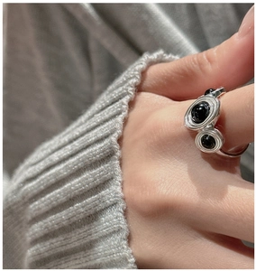 Macro detail of S925 sterling silver ring featuring black agate beads and curvy design