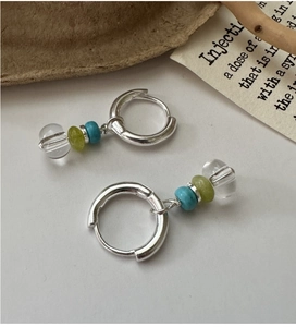 S925 sterling silver hoop earrings with boho clear and green beads on a rustic table