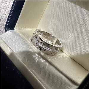 Detail of S925 sterling silver ring with shimmering zircons and textured scales