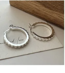 Detailed view of S925 sterling silver hoop earrings with unique gear gear edge design