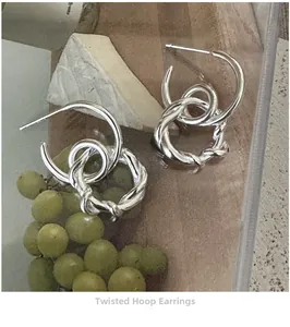 Close-up of S925 sterling silver twisted hoop earrings with elegant double ring design