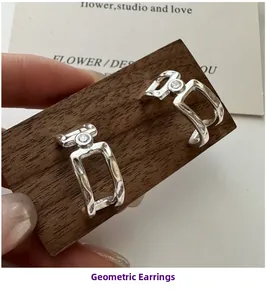 Macro detail of S925 sterling silver geometric C-shaped earrings with round zircon inlay
