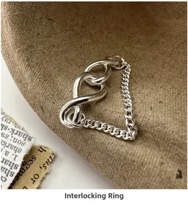 Macro shot of S925 sterling silver chain link cross ring on brown felt texture