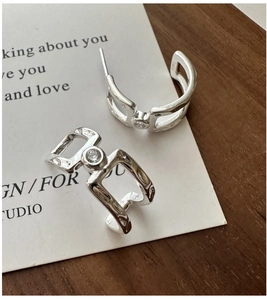 Detail shot of S925 sterling silver earrings with hollow chain design and zircon stone