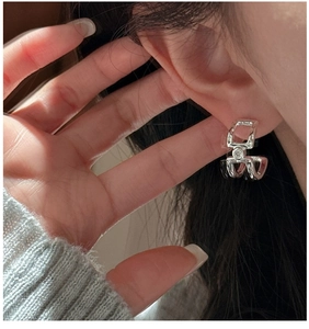 Detail of S925 sterling silver geometric double layer earrings with zircon on a model