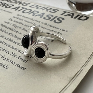 Minimalist S925 sterling silver open ring with dual black onyx gemstones on vintage paper