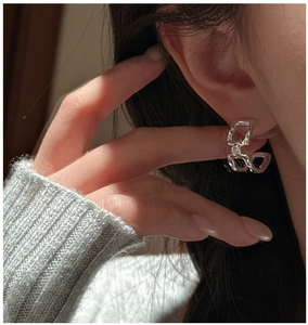 Close-up of S925 sterling silver geometric chain earrings with round cubic zirconia