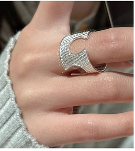 Detailed view of S925 sterling silver ring featuring irregular brushed texture and cutouts