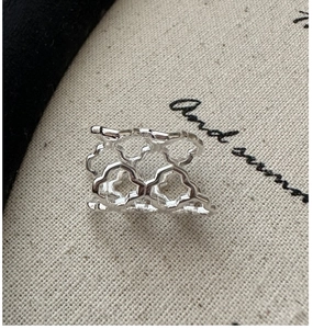 Macro shot of S925 sterling silver ear clip with hollow geometric floral pattern