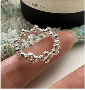 Macro shot of S925 sterling silver beaded ring with polished bubble texture and open band