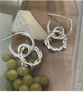 Detail of S925 sterling silver twisted double-loop earrings with vintage spiral texture
