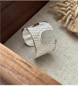 Detailed view of wide S925 sterling silver ring with rustic tree bark texture and C-cut design
