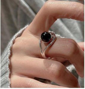 Detail of S925 silver ring featuring a large black agate bead on a minimalist band