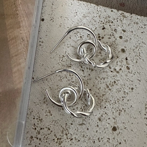 Minimalist S925 sterling silver multilayer twisted hoop earrings on stone background