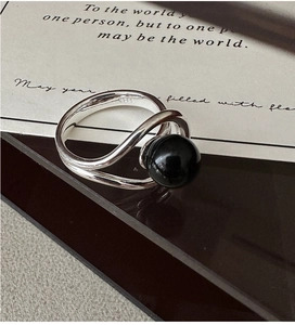 Macro shot of S925 sterling silver ring showing the S925 hallmark and black agate bead