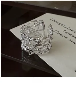 Macro detail of S925 silver hollow woven ring with irregular branch design