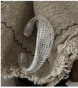 Detail of S925 sterling silver hollow lattice cuff bracelet with a vintage industrial design