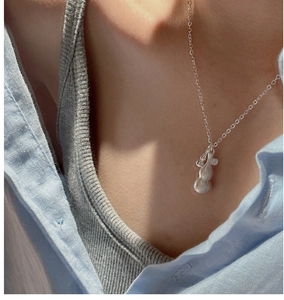 Close-up of 925 silver gourd pendant with matte finish worn on a simple neck chain