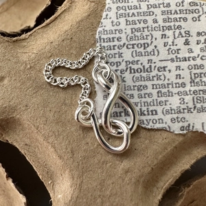 Minimalist S925 sterling silver knot chain ring with vintage paper background aesthetic