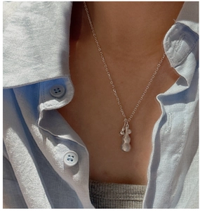 Detail of 925 sterling silver gourd pendant necklace worn on neck with matte finish