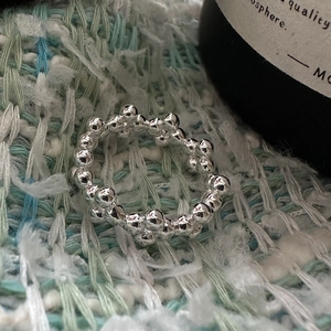 Minimalist S925 sterling silver ring with organic stacked beads on tweed fabric