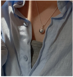 Detail of S925 silver minimalist ball pendant necklace with heart engraving and bead chain