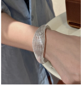 Macro detail of S925 sterling silver hollow mesh bracelet with intricate woven design