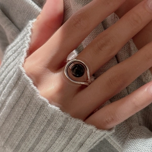 S925 sterling silver ring with large round black onyx bead on grey knit background