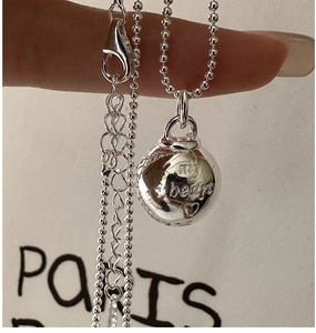 Macro view of S925 sterling silver ball pendant necklace featuring my heart engraving