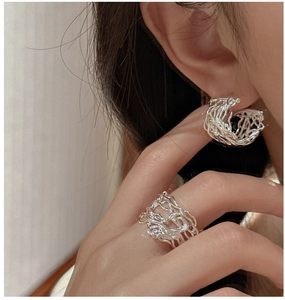 Close-up of S925 silver set featuring textured hollow ring and matching woven earrings