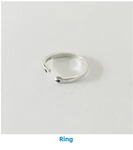 Macro dell'anello aperto in argento S925 con occhi in zircone blu e finitura vintage