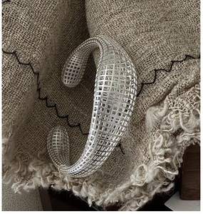 Detail of S925 sterling silver cuff bracelet featuring an intricate 3D hollow mesh design