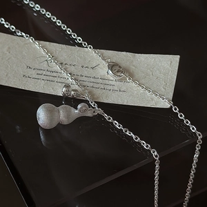 925 Sterling silver Wu Lou necklace with brushed matte finish on a dark reflective surface