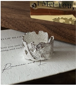 Macro shot of S925 sterling silver ring featuring irregular lava texture and inner hallmark