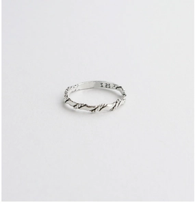 Macro view of S925 sterling silver twisted ring showing authentic hallmark engraving