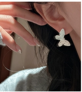 Macro shot of S925 sterling silver butterfly earrings with detailed wing texture