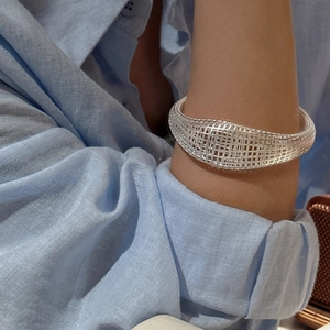 Minimalist S925 sterling silver hollow mesh cuff bracelet with a woven geometric structure