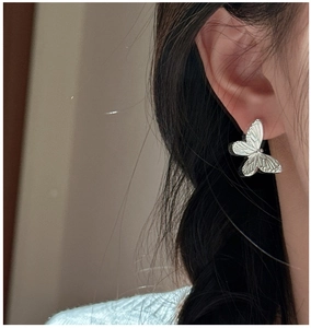 Detailed close-up of S925 sterling silver butterfly stud earring with embossed textures