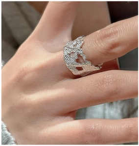 Macro shot of S925 sterling silver ring with molten texture and irregular hollow details