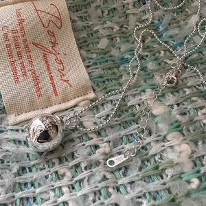 S925 sterling silver ball necklace with heart engraving on minimalist tweed background