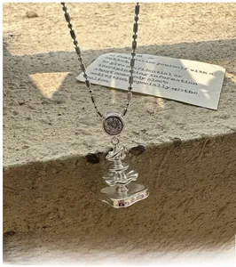 Detailed shot of S925 silver irregular fountain pendant with sparkling zircon on a stone surface