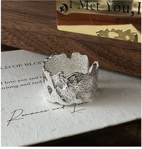 Macro detail of S925 sterling silver ring showing molten texture and silver hallmark