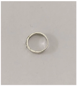 Macro detail of S925 sterling silver ring with irregular hammered texture and vintage finish