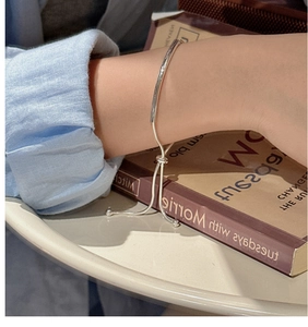 Close-up of S925 sterling silver adjustable bracelet with polished slider bead on wrist