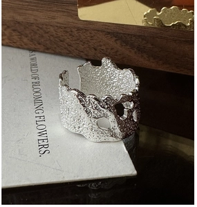 Detailed view of wide irregular molten texture S925 silver open ring on white card