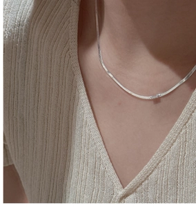 Detail of S925 silver herringbone necklace with a rectangular zircon on model